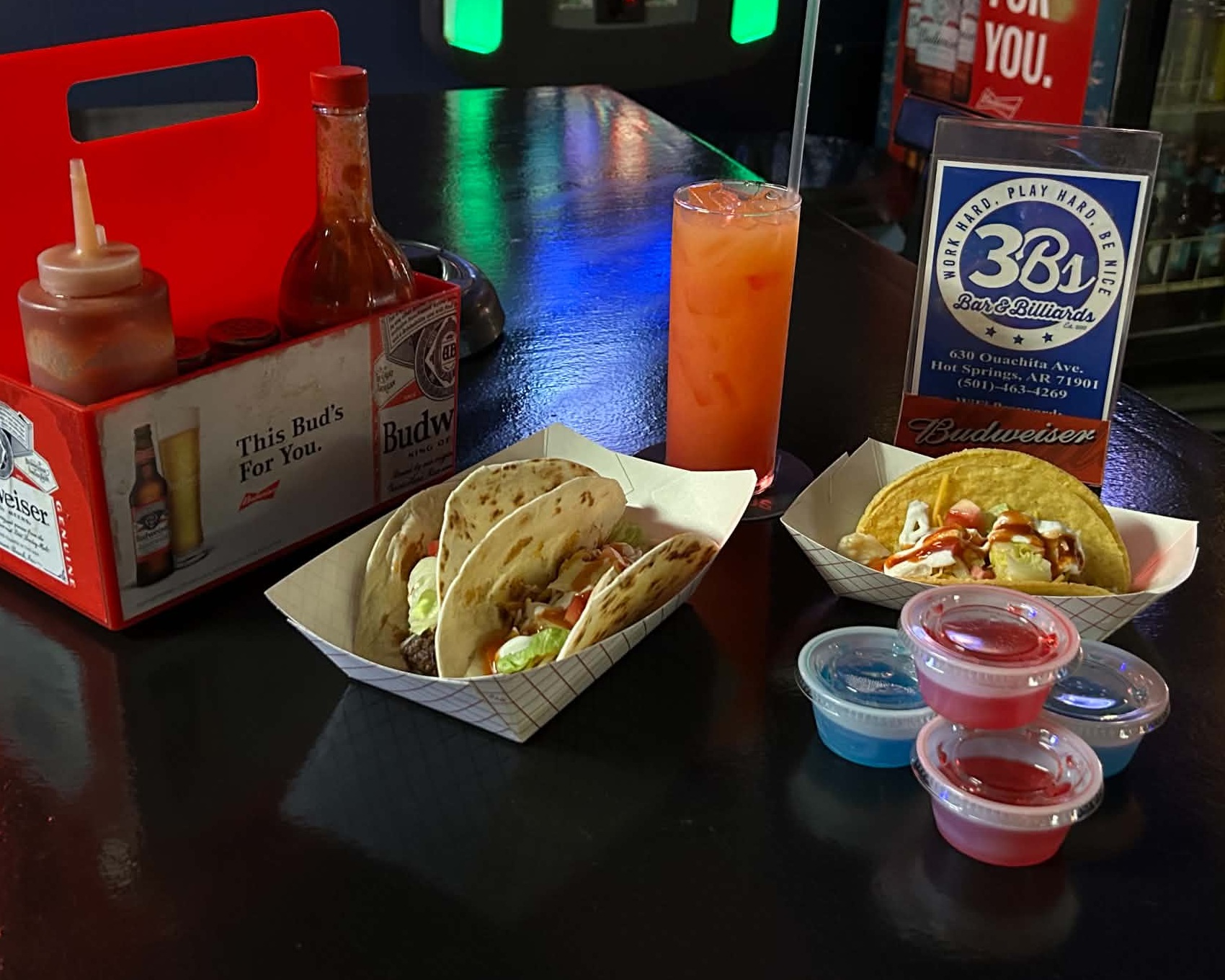 Three tacos, salsa, and a drink beside the jukebox at 3B’s